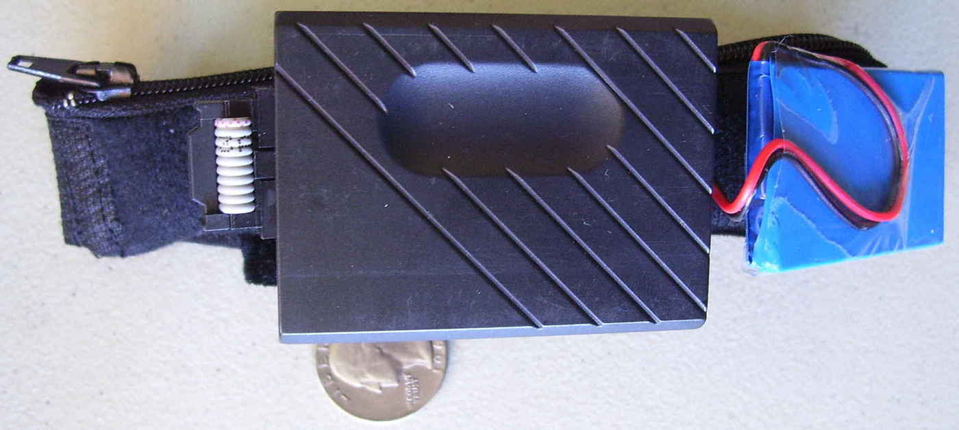 Close-up of North Paw case & externally-mounted battery (quarter for scale).