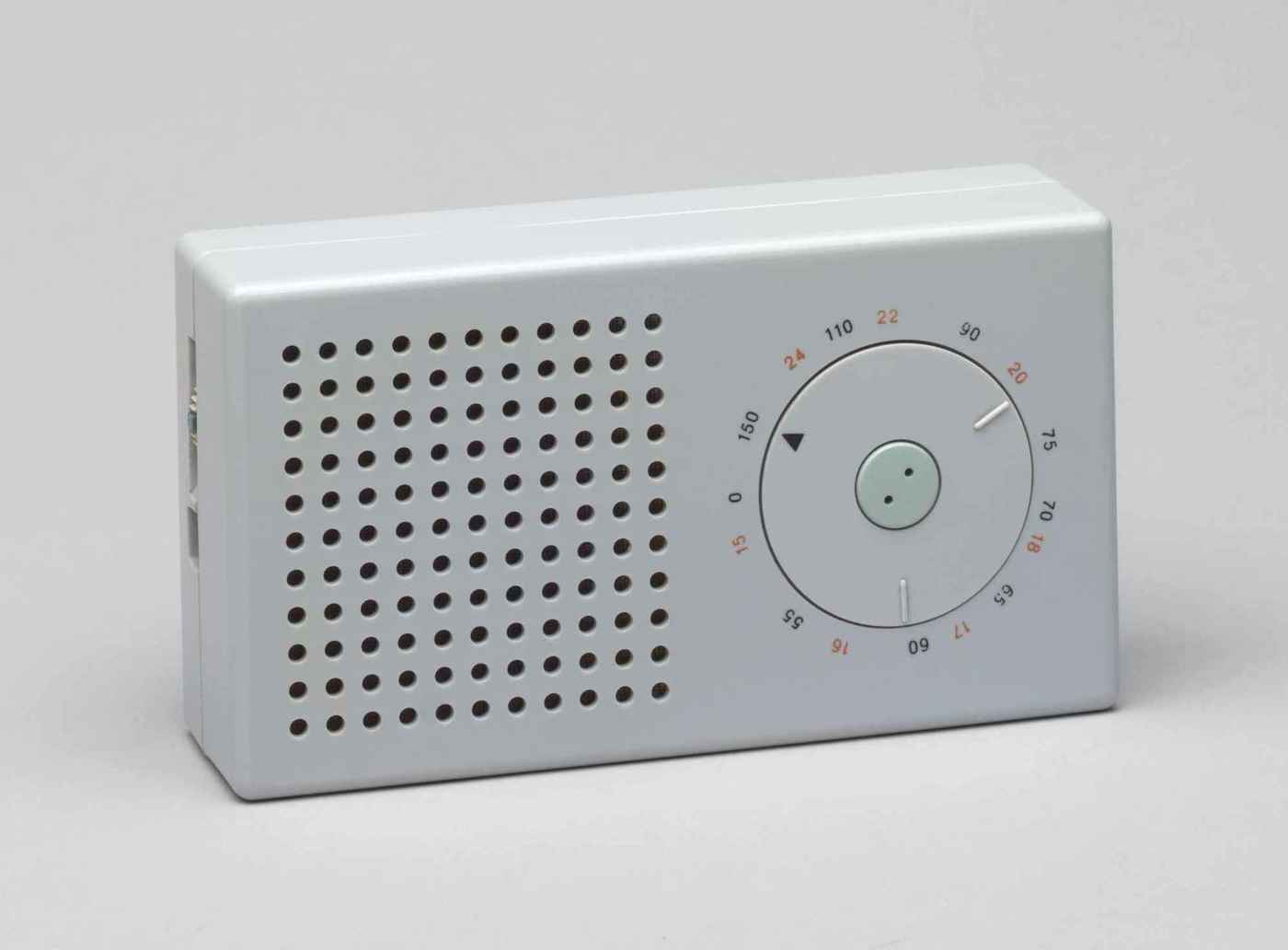 The iconic Braun T3 pocket transistor radio, designed by Dieter Rams (1958; MoMA photo); though somewhat faded, the red (one of only 3 colors on the device) numerals still clearly denote longwave radio frequencies (black for medium wave length). It strikingly resembles the Apple iPod, which, however, is all-white.